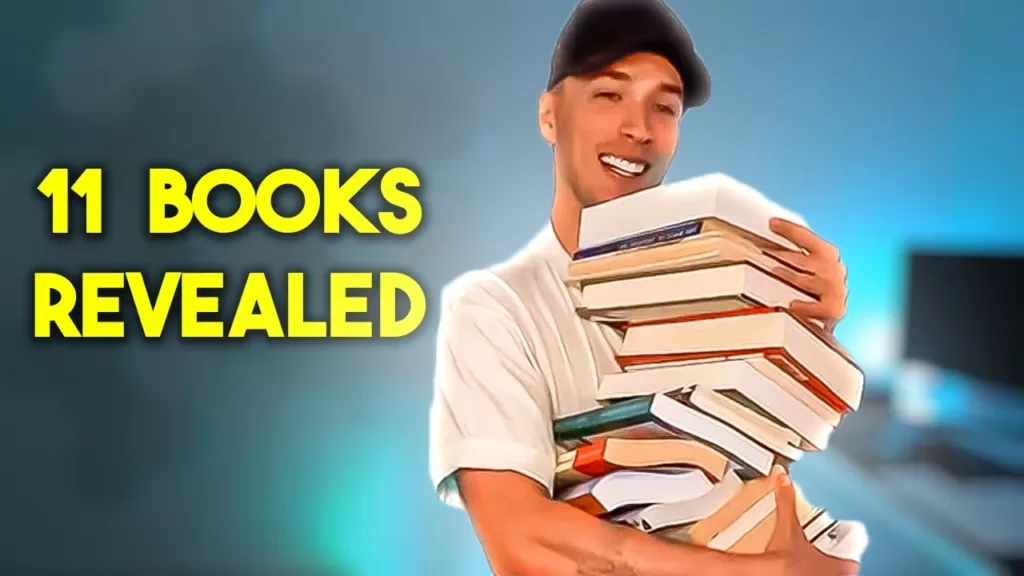 luke belmar holding his 11 book recommendations for success